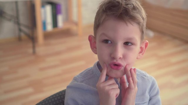 Close up preschooler engaged with speech therapist