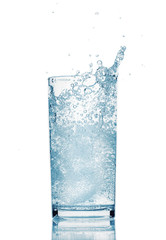 one glass of water with splash from falling ice cube, white background, isolated object