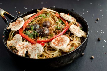 Delicious Vegetarian spaghetti served with mushroom topping, red pepper, paprika, pepper, black olive and sea salt