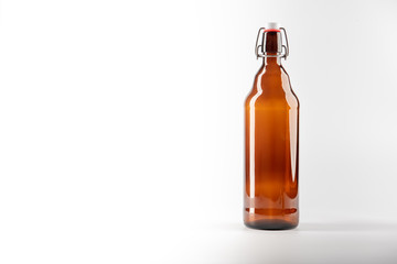 A brown bottle with a clip lock cork set against a white background