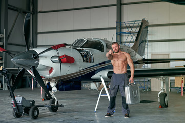 technician in the hangar with the plane