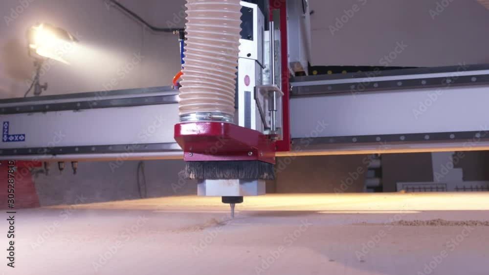 Poster Close-up of wood cutting machine controlled by computer while he is carving wood. Action. CNC milling machine carving a wooden part blank.