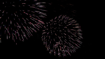 Obraz premium A beautiful Fireworks light up the sky with dazzling display on dark background.