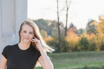 Beautiful young girl is posing in autumn light