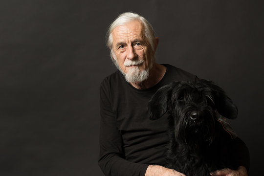 Low Key Studio Portrait Of Old Man And His Dog