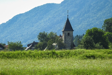 Old historic church in the village of Ratece, Slovenia on a sunny day in summer