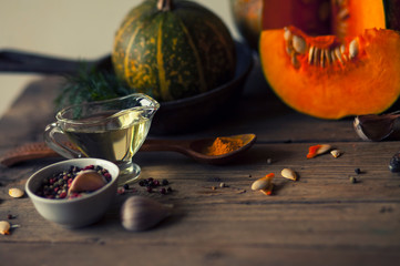 pumpkins with spices and greenery on the table  .ingredients for soup or other pumpkin dishes.healthy organic food .top view