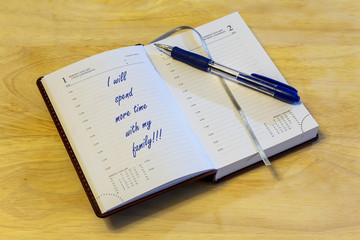 The diary is on the table. The diary is open on the first of January page. On the page it is written: 