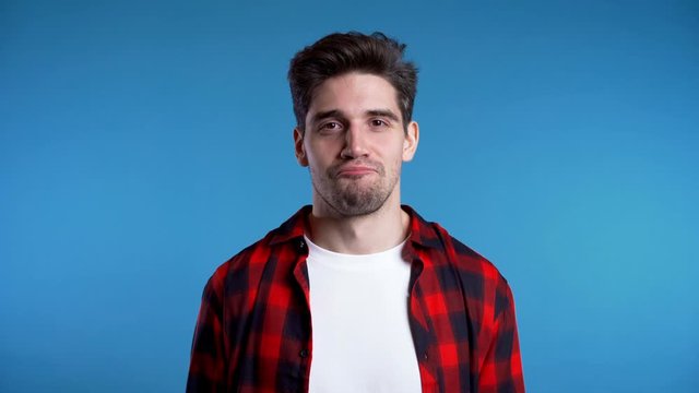 Happy ecstatic man screaming of joy. Excited champion guy celebrating winning. Guy approvingly shakes his head, probably with envy about good news of interlocutor