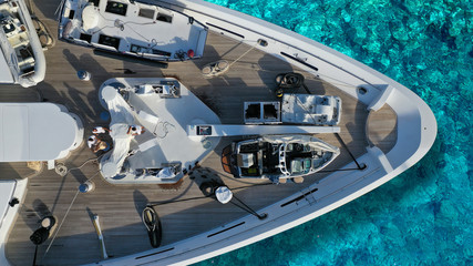 Aerial top down detail photo of yacht nose docked in tropical exotic bay with turquoise clear sea