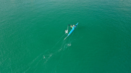 Aerial drone top down photo of kayak athlete competing in tropical exotic lake with green water