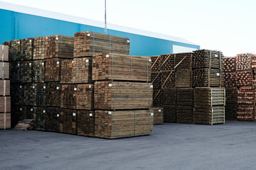 Packaged lumber in a trading port. Wooden cargo on the pier.