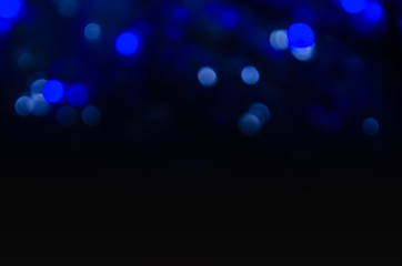Abstract pattern of bokeh garland lights on a dark background