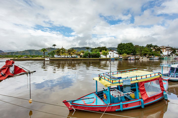 Boat dock at Paraty Bay in Rio de Janeiro, Brazil, where passenger boats await tourists to be taken to nearby islands or other villages.