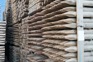 Packaged lumber in a trading port. Wooden cargo on the pier.