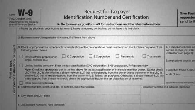 W-9 Tax Form. Push in on the tax document to the a close up on "W-9".