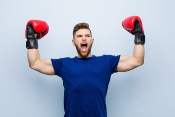 Young caucasian man wearing a boxing gloves