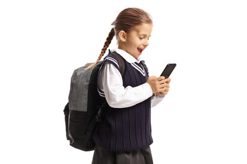 Happy little schoolgirl holding a mobile phone