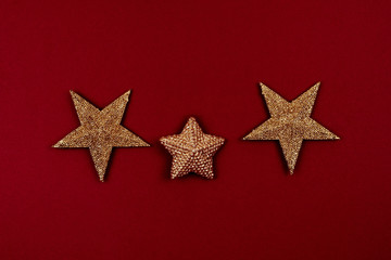 Three golden stars on a red background. Feedback concept. Reviews