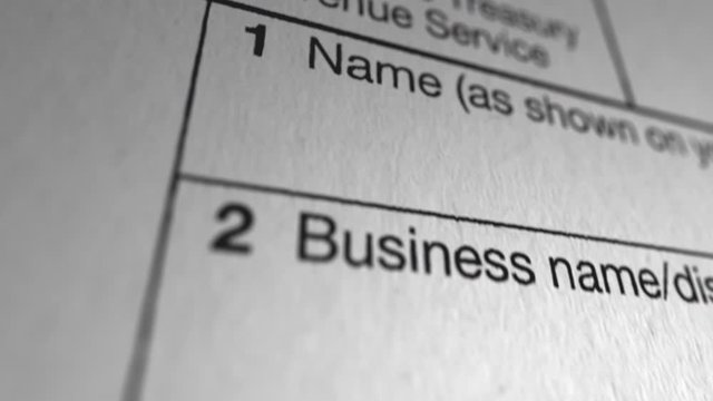 W-9 Blank Tax Form. Macro shot flies down each section of a blank W-9 tax document.