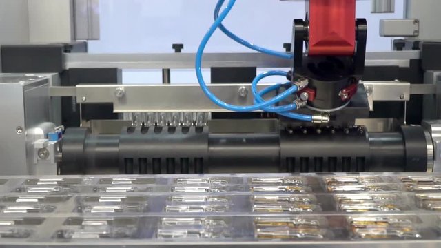Equipment for pharmaceutical and chemical industry,the operation of the manipulator for packing vials of medicine, slow motion