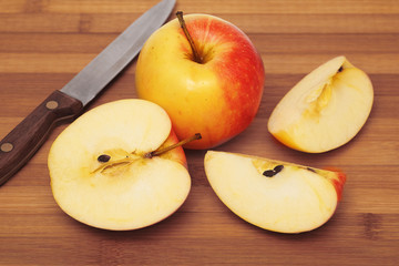 Whole apple and cut up apple on cutting board