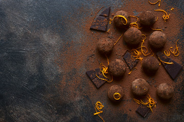 Homemade delicious chocolate truffles with orange. Top view with copy space.