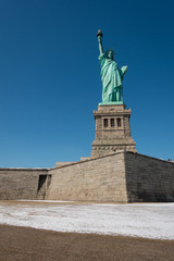 Statue of liberty frontal shot at liberty island in wintertime with snow visible. © Chris