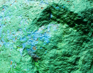 Old painted granite stone rock background. Green, cyan, turquoise, aquamarine.