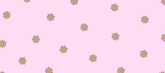 Winter pattern made of snowflakes and on pink background.