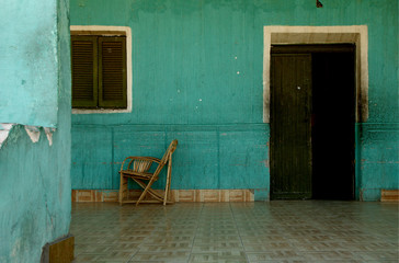 Fototapeta na wymiar green wall with door and chair