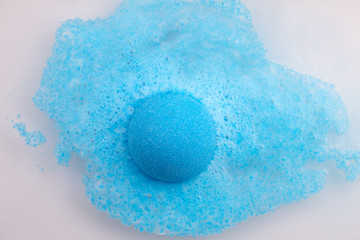 Blue bath bomb foaming in water