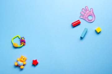 Colorful kids toys frame on wooden background. Top view. Flat lay. Copy space for text.