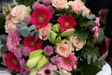 A beautiful bouquet of different flowers lies on the table