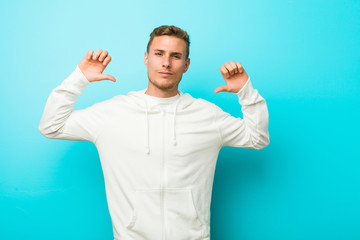 Fototapeta premium Young caucasian sport man feels proud and self confident, example to follow.