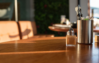 Close up cinnamon powder for coffee and sugar on the table in the cafeteria. Copy space, morning coffee time.