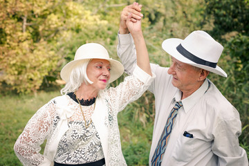 Seniors couple dancing in nature