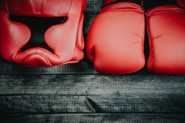 Boxing helmet and boxing gloves isolated on wooden background. Concept of sport and active leisure....
