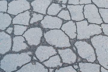 A fragment of cracked old asphalt