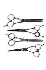Set of hairdressing scissors on white background. Professional hairdressers equipment, top view.