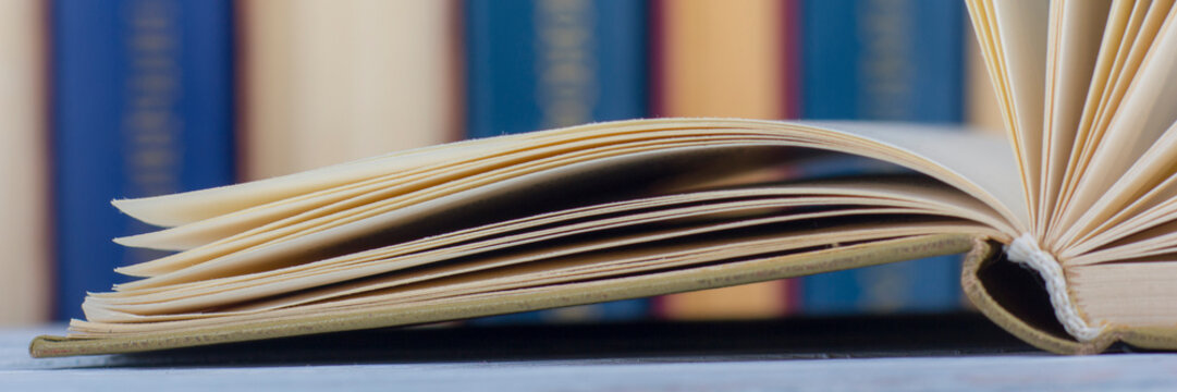 Open book, hardback books on wooden table. Back to school. Copy space