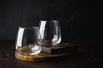 Two empty glasses on small wooden cutting board
