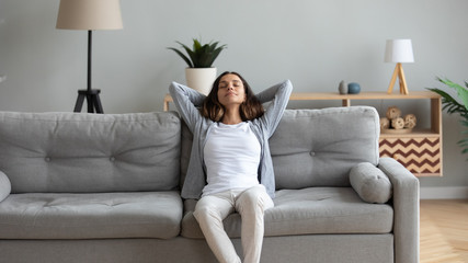 Obraz premium Attractive woman leaned on couch resting in living room