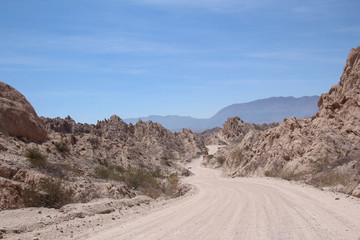A road crosses between the rocky peaks of La Quebrada de las flechas, Argentina