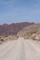 A road crosses Argentina's beautiful and colourful mountains