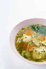 Classic chicken noodle soup with carrot and parsley isolated on white