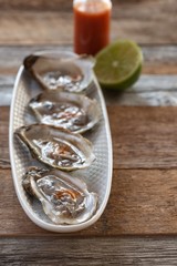 Oysters with lime and hot sauce.