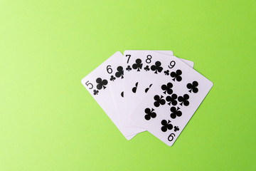 The combination of playing cards poker casino. Isolated on green background. From above