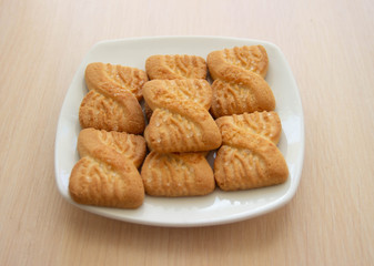 The photo of a pile of  cookies or shortcake biscuits on the plate. National Cookie Day background