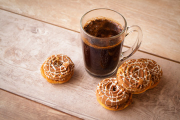 Cup of coffee with cookies on rustic wooden background, image in beige and brown colors.
